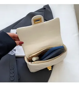 Interior view of beige quilted crossbody bag showing space for phone and makeup