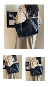 Detail of black woven leather tote bag texture with spacious interior and double straps