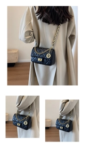 Detail of black quilted shoulder bag featuring gold chain and metallic brand tag