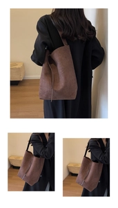 Detail shot of a brown suede oversized tote bag featuring decorative long tassel ties