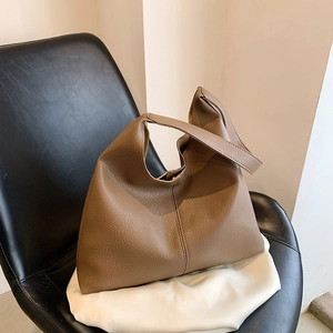 Brown litchi grain leather tote bag for women featuring minimalist bucket style design