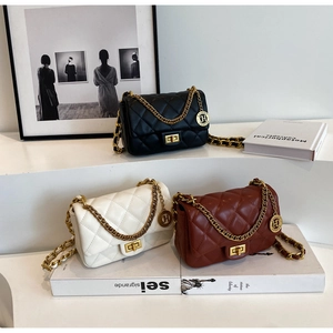 Detailed view of quilted chain shoulder bags in black, white, and red with gold hardware