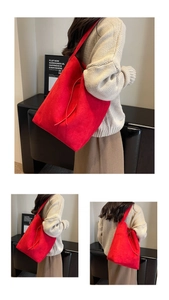 Macro view of large red suede tote bag showing soft texture and minimal side tie detail