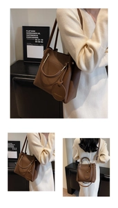 Detailed view of a brown pebbled leather bucket bag with metallic ring handles and strap