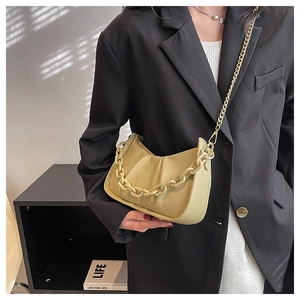 Detail of khaki cloud bag featuring ruched texture and bold matching chain strap