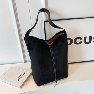 Large black suede tote bag with minimalist wide strap and contrasting brown lining