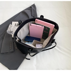 Internal view of a large woven tote bag showing space for tablets and daily essentials