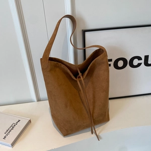 Brown suede tote bag for women with drawstring detail and minimalist retro shoulder style