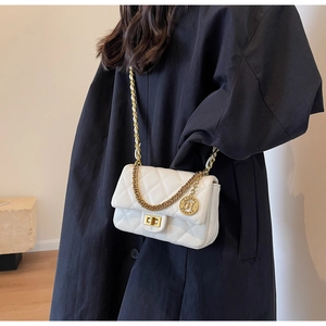 Detail of white quilted crossbody bag with gold chain strap and square metal lock