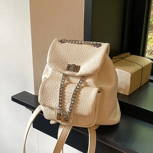 Creamy white leather backpack with silver chain detail and dual front pockets