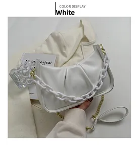 Detail of white cloud bag with decorative resin chain and metallic shoulder strap