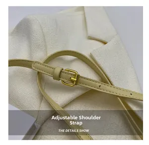 Detail of beige leather adjustable shoulder strap with premium golden metal buckle
