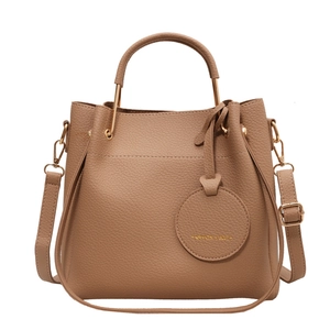 Brown litchi grain leather bucket bag with top handle and gold hardware detail
