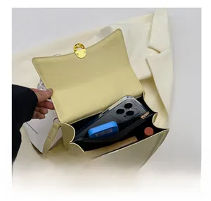 Interior view of beige small square crossbody bag with two compartments and zipper pocket