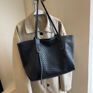 Classic black woven tote bag with diamond pattern and long handles for autumn style