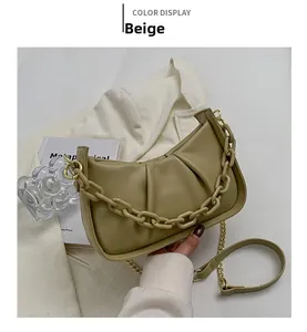 Macro view of olive green cloud bag featuring elegant pleated texture and chain detail