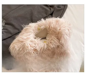 Close-up of soft plush handbag featuring interior gold magnetic clasp closure detail