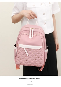 Detail of pink nylon backpack featuring diamond quilted pattern and gold rivet accents