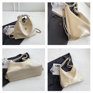 Detail of off-white leather shoulder bag with metallic M logo and dual chain strap