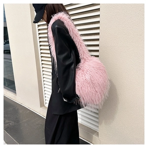 Close-up of fluffy pink faux fur shoulder bag texture and plush material detail
