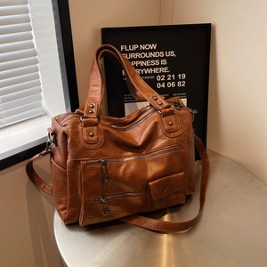 Brown leather large capacity travel bag with multiple zippers and adjustable strap