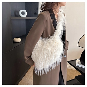 Detail of white fluffy faux fur shoulder bag with soft textured fringe for winter style