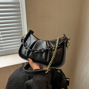 Fashionable black pleated cloud bag with stylish acrylic and gold chain shoulder straps