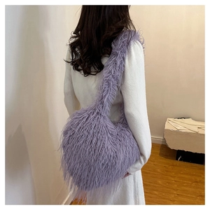 Detail of soft purple plush texture and fluffy faux feather material on a shoulder bag