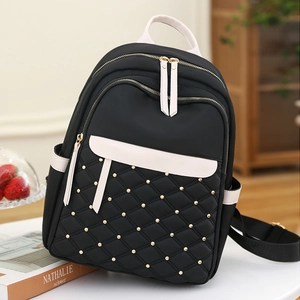 Chic black nylon quilted backpack for women featuring white contrast trim and gold hardware