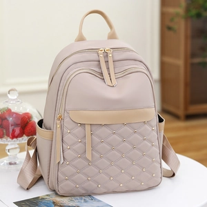 Minimalist beige quilted nylon backpack for women with gold rivets and large capacity