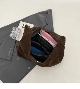 Interior view of large brown suede tote bag showing storage for tablet and books