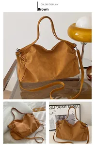 Detail of a brown large tote bag with a matte texture and adjustable shoulder strap