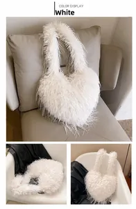 Detail showing plush heart-shaped white faux fur shoulder bag texture and shoulder strap