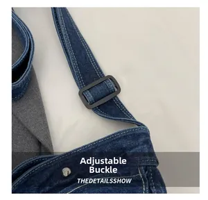 Detail of adjustable black buckle on blue denim shoulder bag showing fabric texture