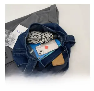 Interior view showing large capacity of the denim tote bag with daily essentials inside