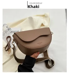 Detail of khaki saddle bag with asymmetric wave flap and dual textured shoulder straps