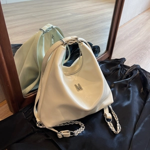Chic cream white half-moon crossbody bag with silver M logo and chain strap details