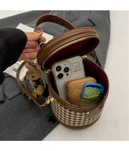 Spacious interior of houndstooth bucket bag showing phone and wallet storage