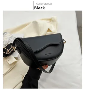 Detail shot of a black saddle bag featuring unique wavy texture and dual shoulder straps