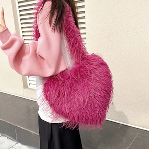 Fuzzy heart-shaped shoulder bag in rose red plush faux fur with a matching wide strap