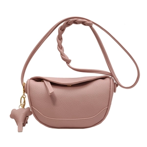 Pink lychee grain leather crossbody dumpling bag with elephant charm and woven strap