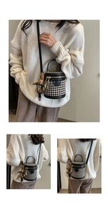 Detail of vintage houndstooth bucket bag with black leather trim and cute bunny charm