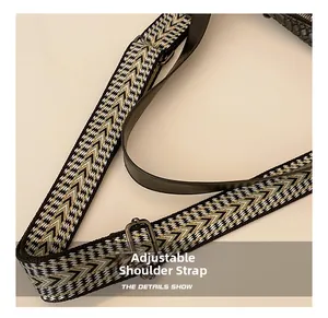 Macro detail of multi-color woven shoulder strap with adjustable gunmetal buckle