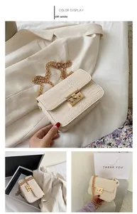 Close-up of cream crocodile pattern flap bag with gold chain and metal lock buckle
