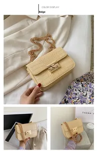 Close-up of yellow crocodile texture leather and golden metal chain buckle on crossbody bag