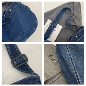 Detail of dark blue denim messenger bag with contrast white stitching and metal buckles