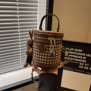 Retro houndstooth bucket bag with leather trim and brown knit rabbit charm detail