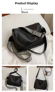 Detail of black woven crescent bag featuring a geometric ethnic style shoulder strap