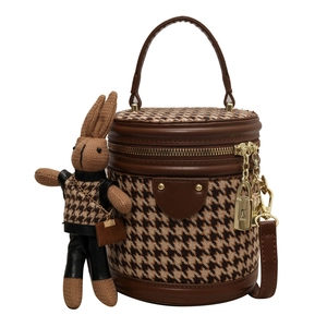 Brown houndstooth bucket bag with round top handle and cute rabbit pendant charm