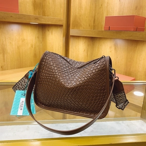 Dark brown woven shoulder bag with wide jacquard strap and minimalist cross-body design